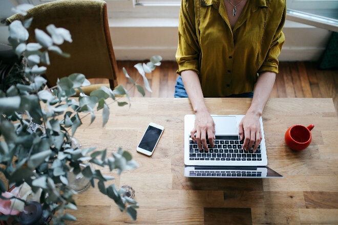 Overhead image of a lady typing on the laptop 